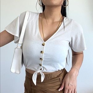 White crop top 
Material: cotton
Texture: flowy, drapes
Slightly see-through